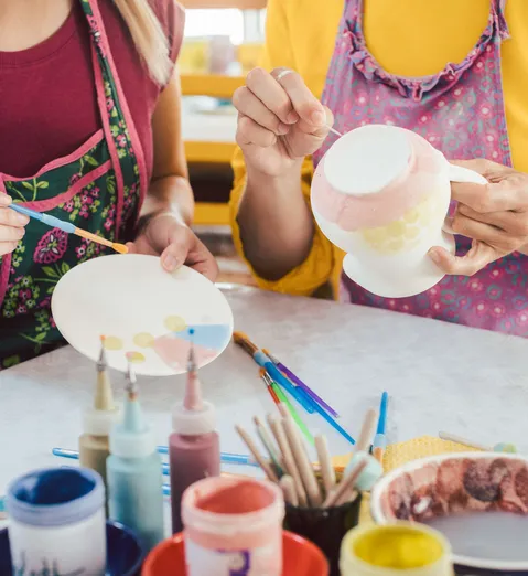 люди раскрашивают посуду