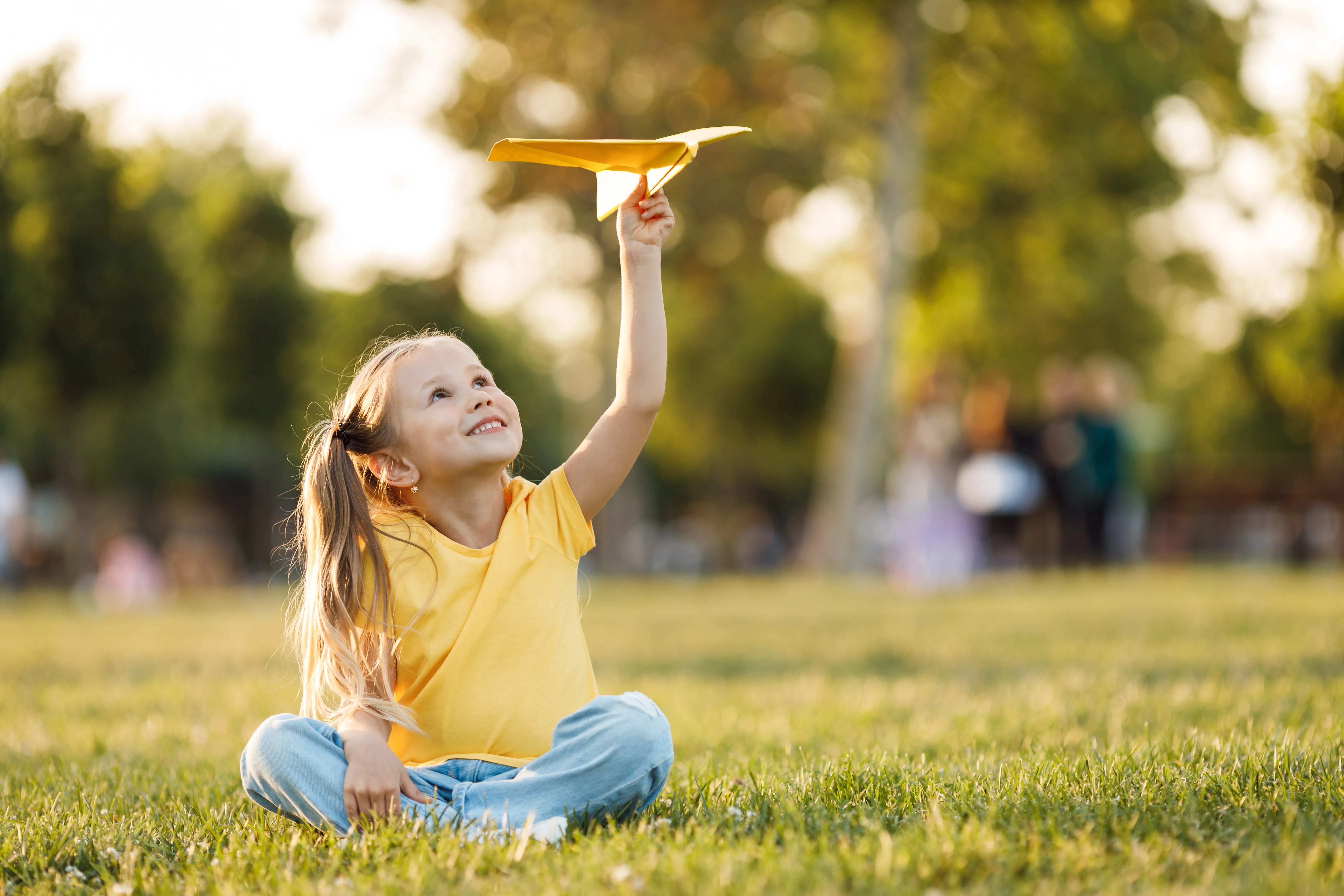 cute-little-girl-with-paper-plane-outdoor