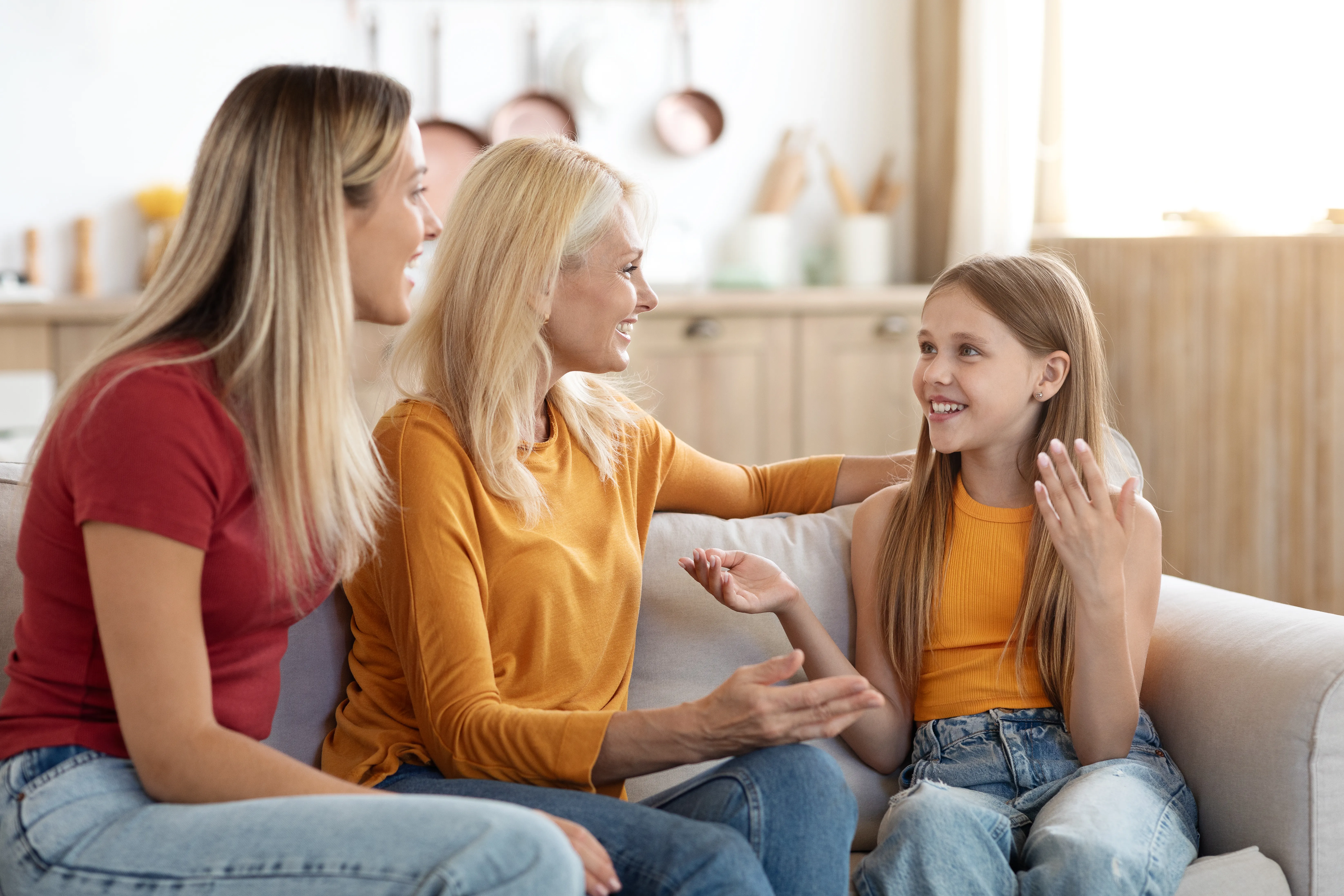 cute-preteen-blonde-girl-sharing-secrets-with-mom-granny