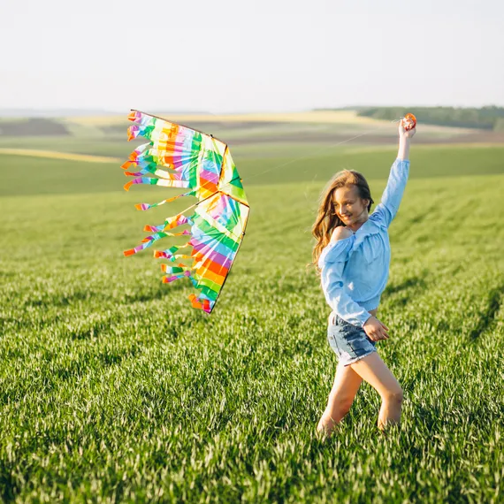 девочка играет с воздушным змеем