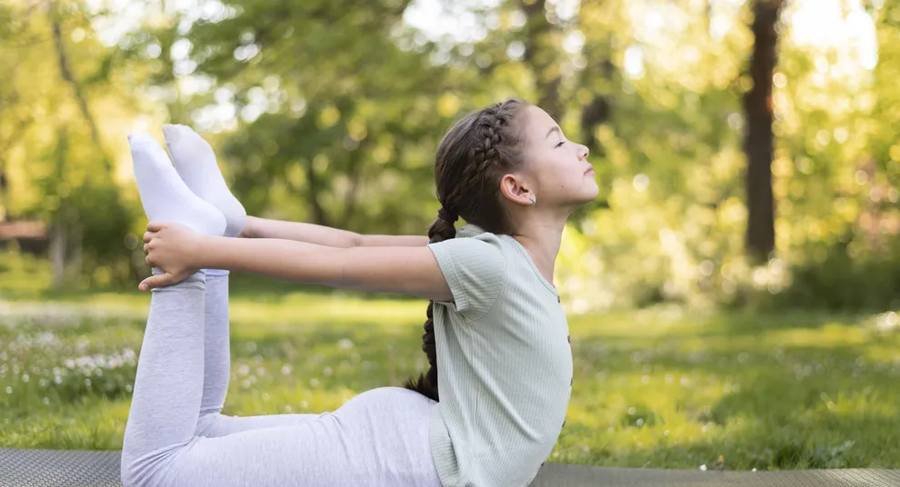 full-shot-girl-exercising-yoga-mat-outside