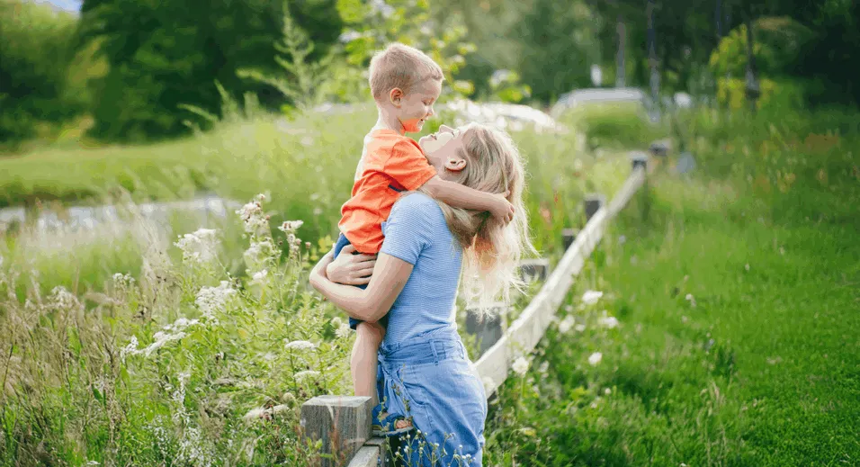 mothers-day-holiday-young-caucasian-mother-boy-toddler-son-hugging-embracing-park-outdoor