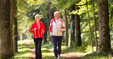 seniors-jogging-forest-road