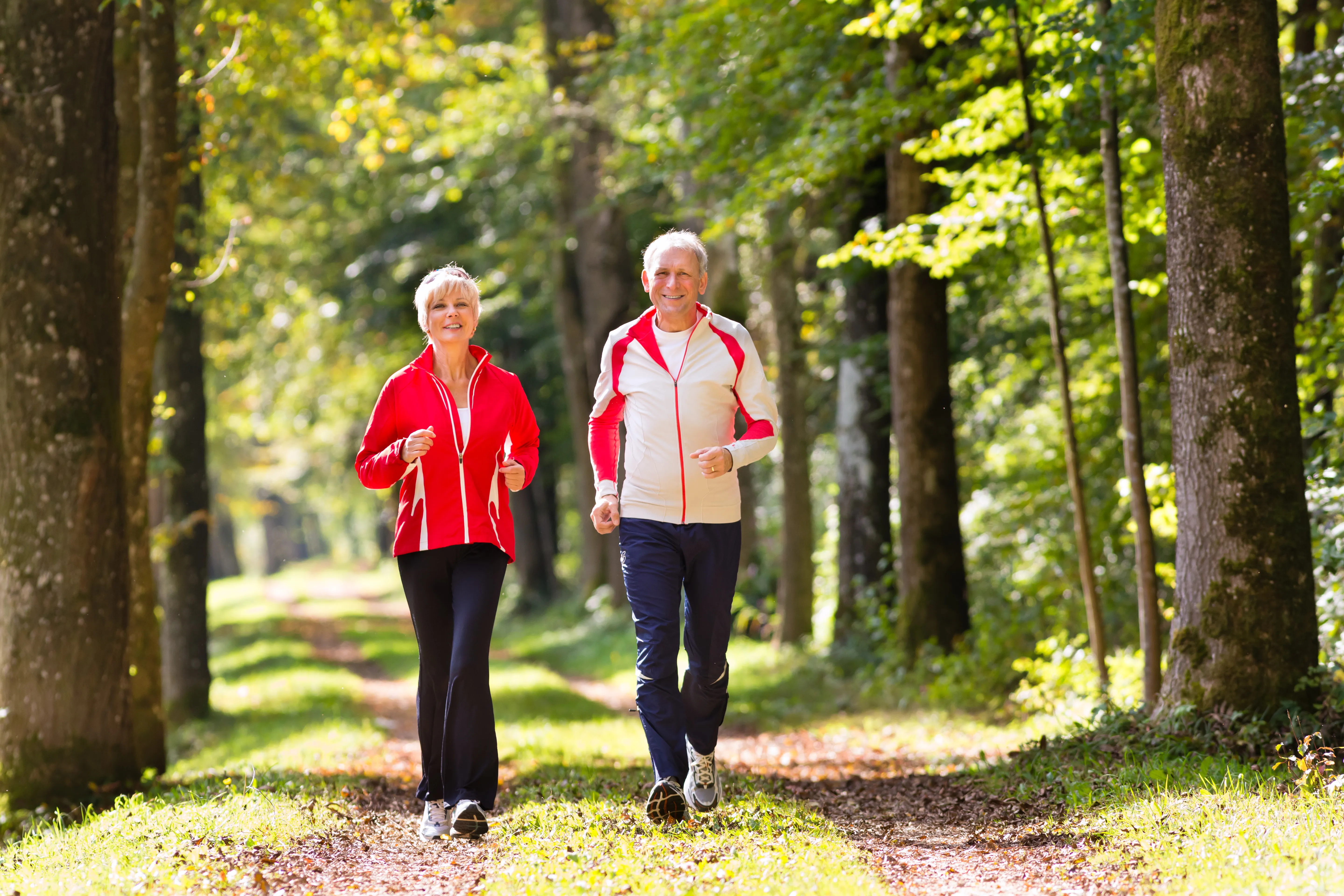 seniors-jogging-forest-road