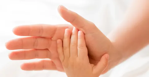 top-view-mom-holding-baby-s-hand