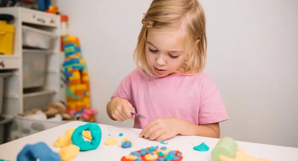 young-child-engaged-creative-play-with-colorful-modeling-clay-home-afternoon